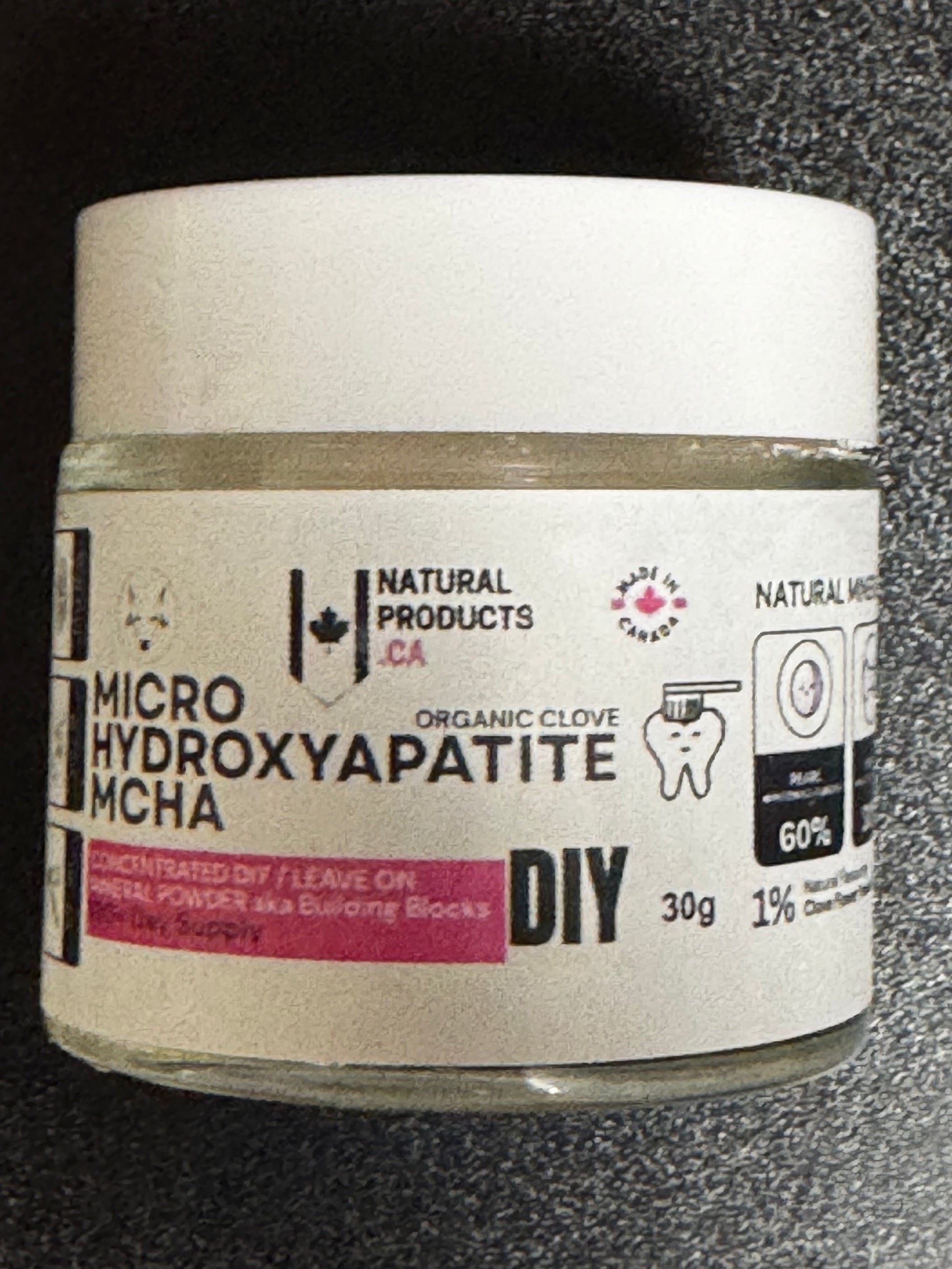 Jar of micro hydroxyapatite with a label on a dark background